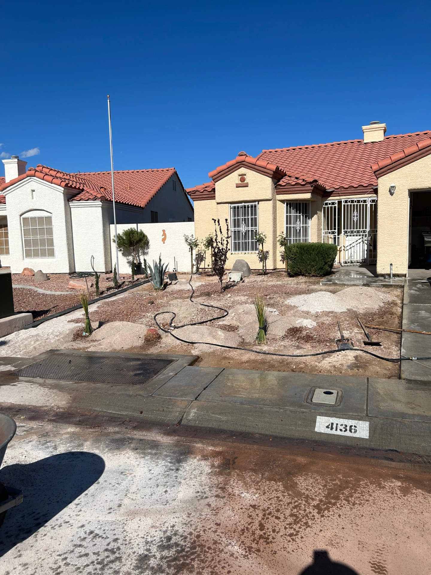 Front yard landscape installation in progress with new plantings