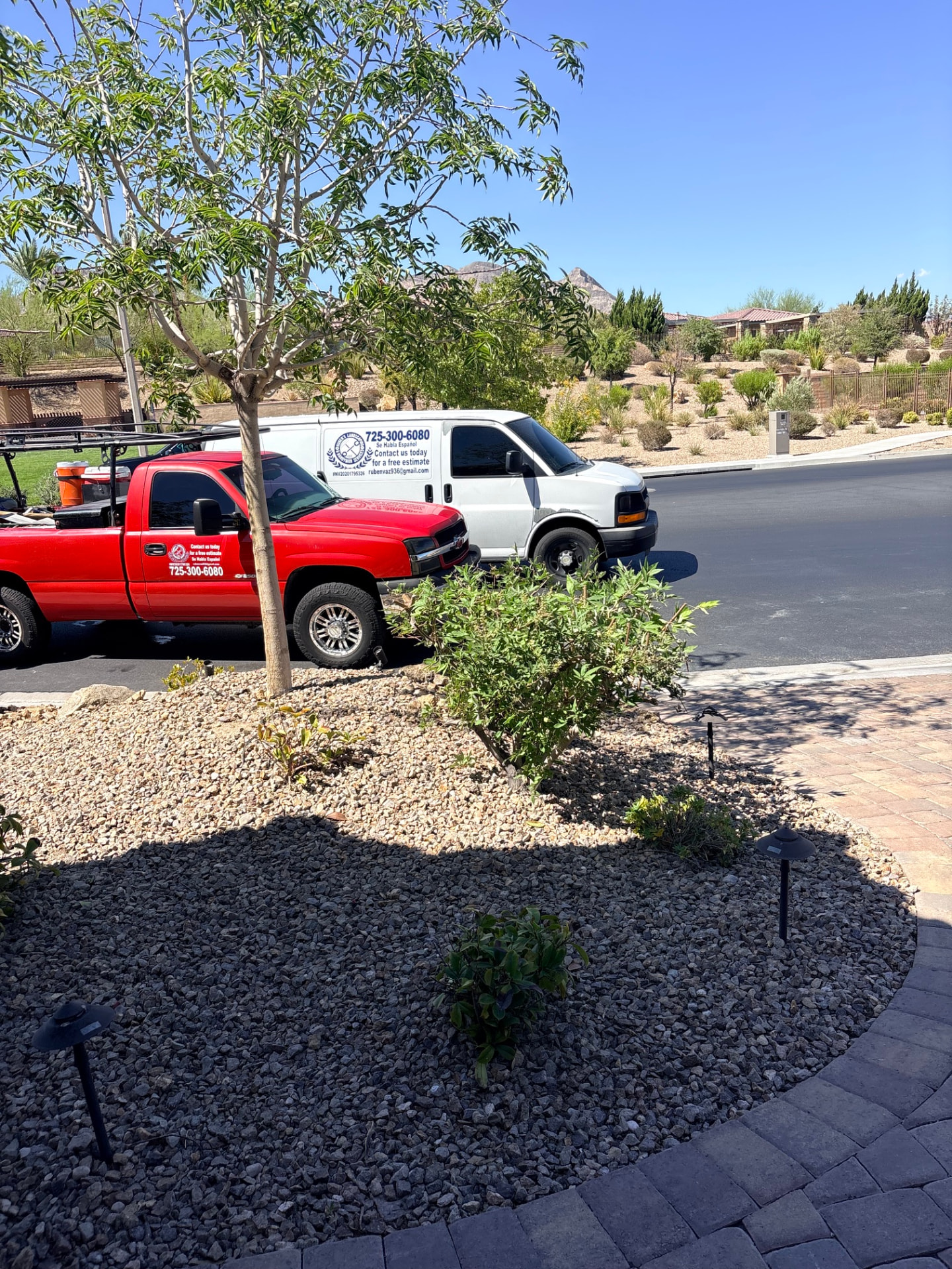 Ruben's Landscaping & Handyman service trucks on a residential street