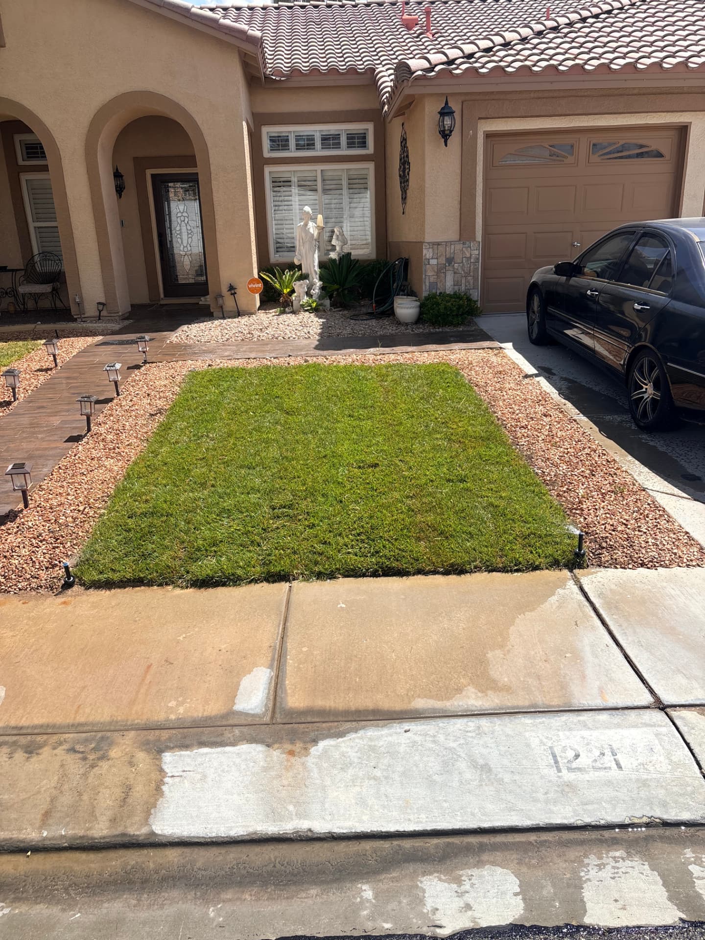 Finished front lawn with decorative rock landscaping